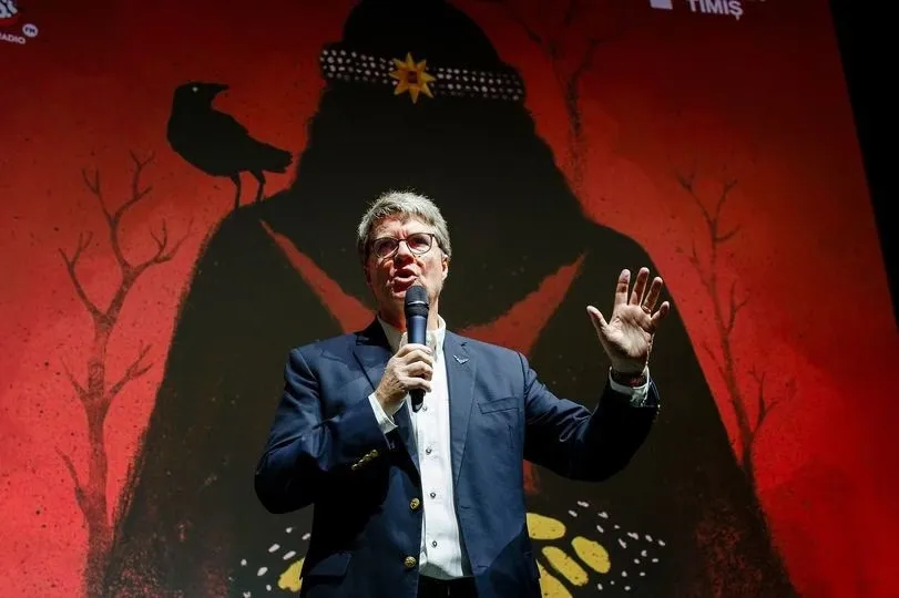 Dacre Stoker speaking on stage, from the supplied event brochure